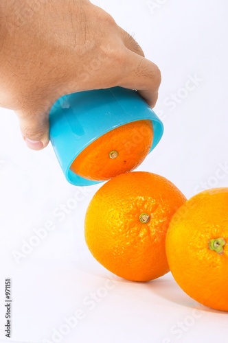 three oranges with bright blue cup photo