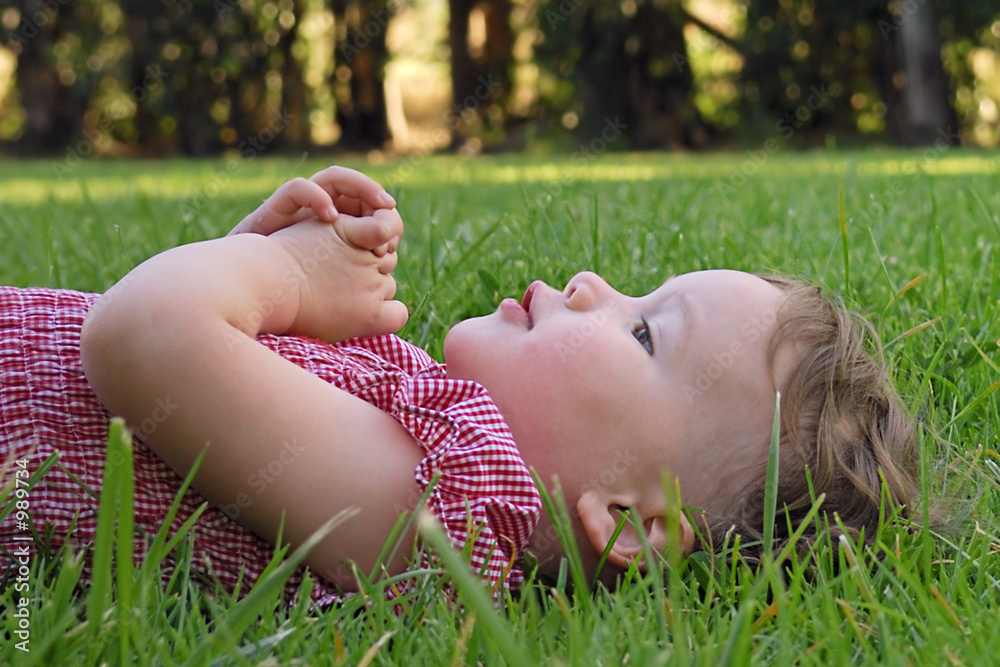 cute toddler lying on the grass