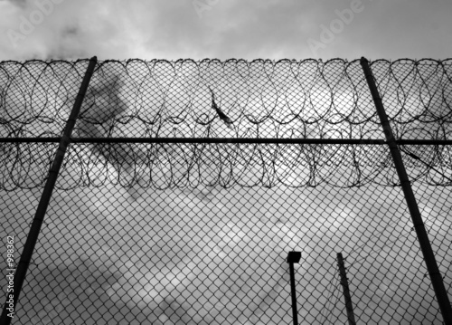 forbidding razor wire prison fence