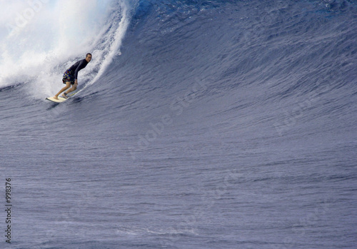 surfer goes left in big waves