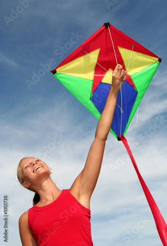 happy young woman flying a kite