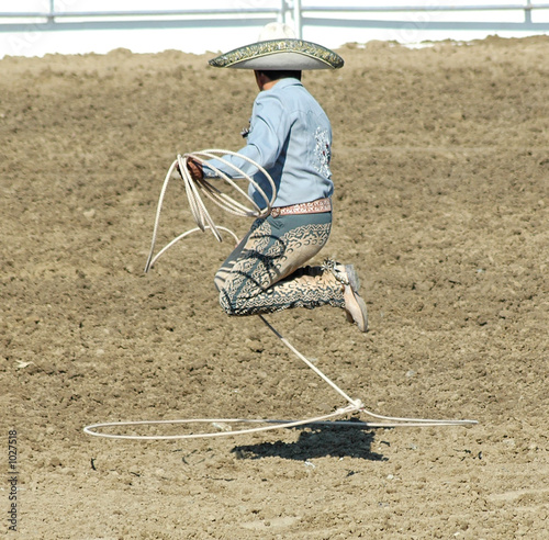 mexican cowboy doing rope trick photo