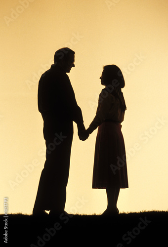 silouette of couple holding hands