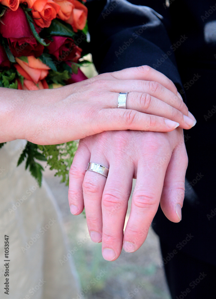 newly weds hands with wedding rings