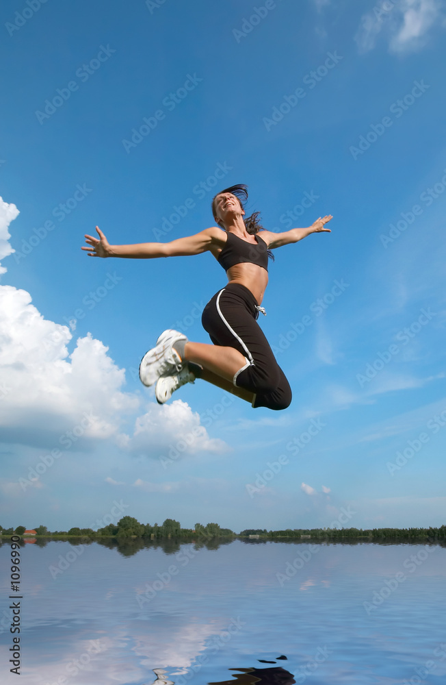 woman jumping above water