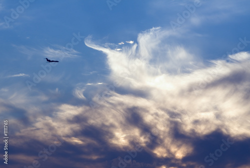 air-liner in evening cloudy sky