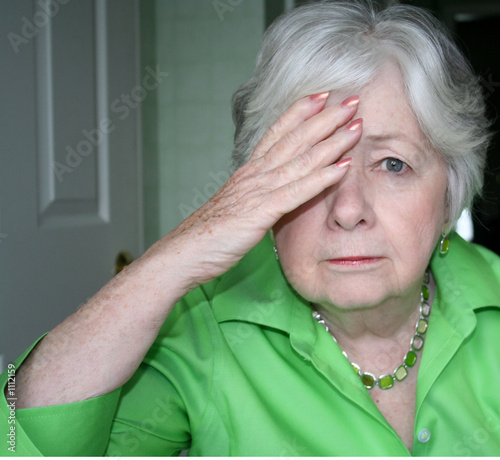 woman with one hand to head