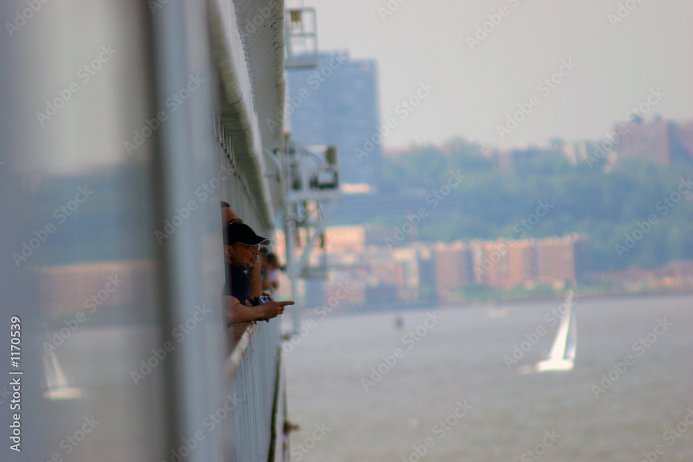 people looking at the city from a cruise ship people looking at the city from a cruise ship