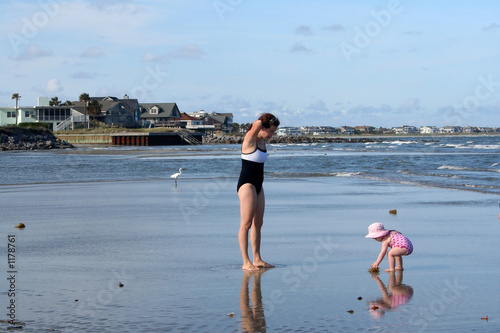 mother playing with daughter on beach