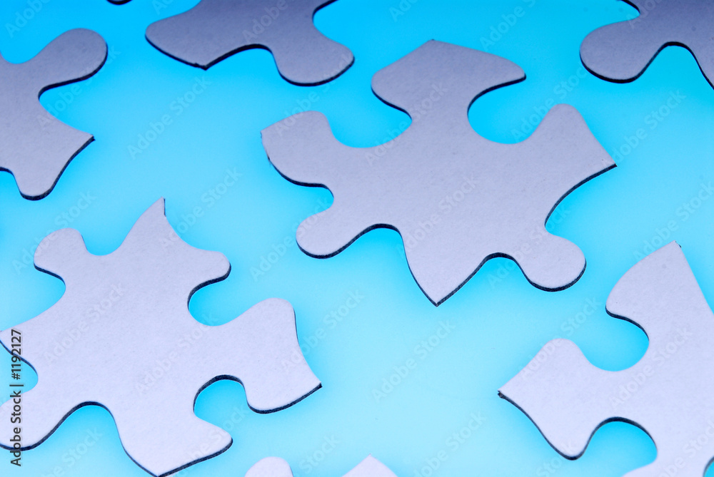 puzzle pieces on light blue puzzle pieces on light blue