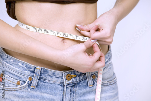 girl measuring her waist