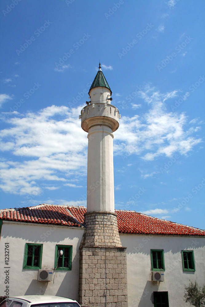 View of minaret against cloudy sky