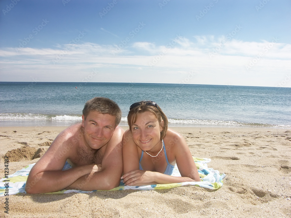 young happy couple on the beach
