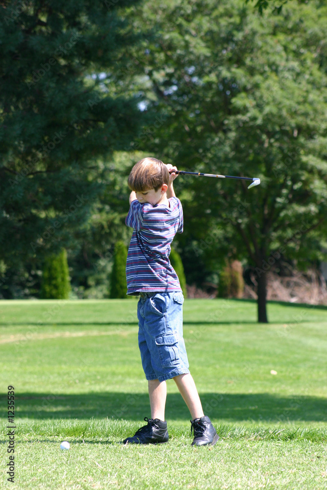 boy swinging golfclub