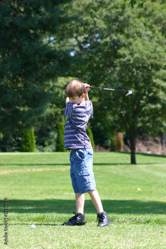 boy swinging golfclub