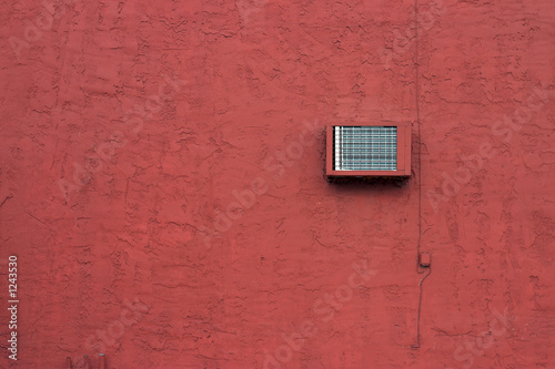 red stucco wall with air conditioning unit