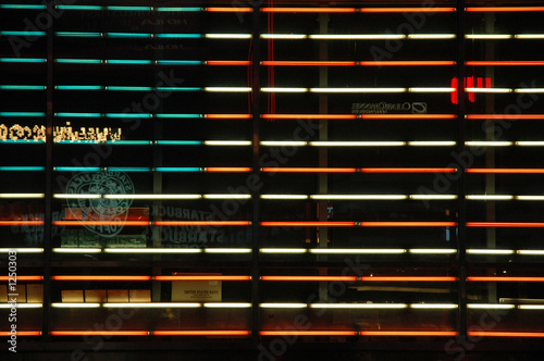 american flag in neon lights with reflections on times square