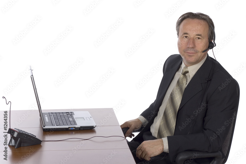 businessman at the desk with headset businessman at the desk with headset