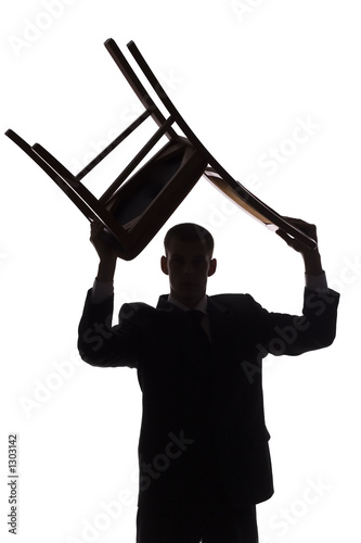 Photography silhouette of man with chair over his head