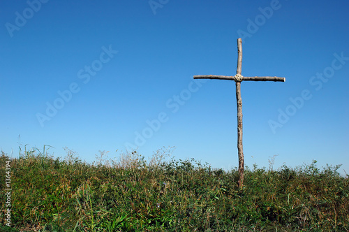 rustic cross over blue sky