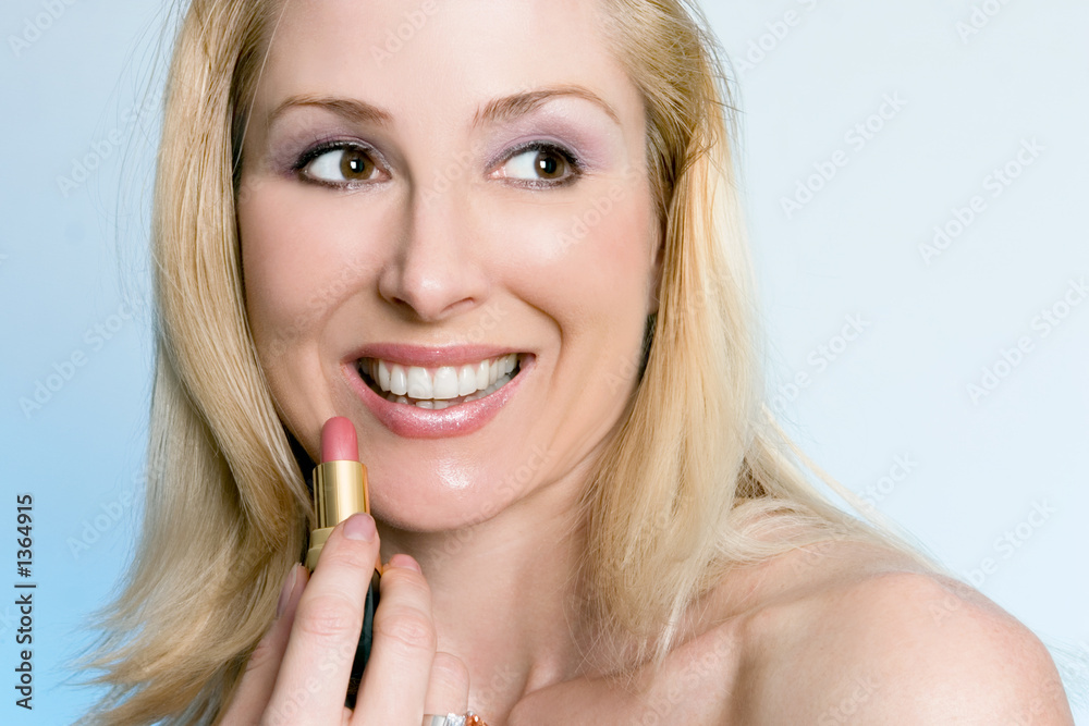 beauty - happy female applying pink lipstick beauty - happy female applying pink lipstick
