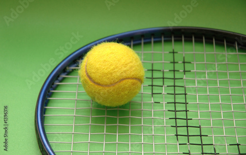 tennis racket and ball on green background