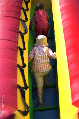 young boys climbing inflatable bouncy