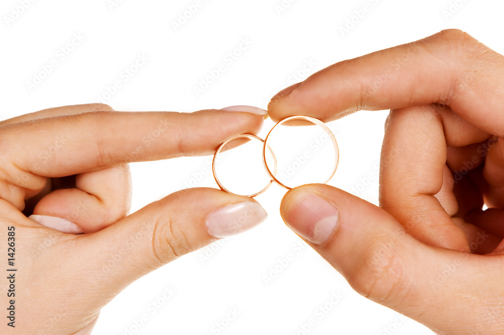 man woman fingers holding rings