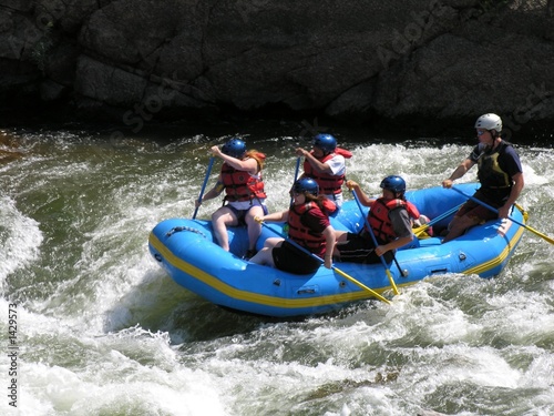 group of friends white water rafting in colorado.
