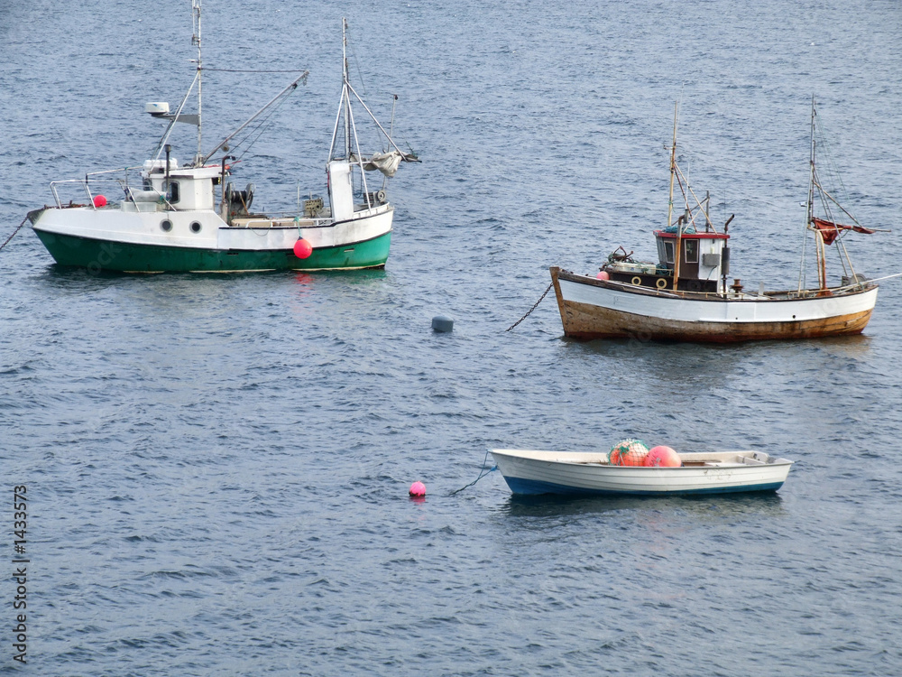 two fishing ships and a boat on anchor