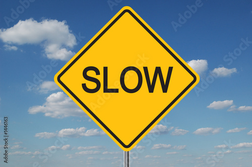 slow traffic sign with clouds