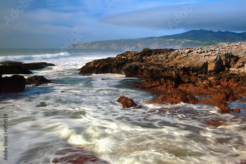 beach with rocks  waves stream and fog