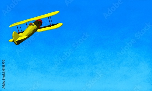 yellow biplane soaring