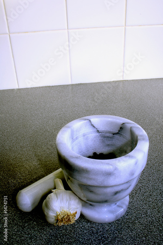 pestle and mortar with black pepper and garlic