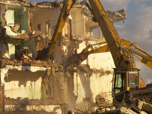 demoliton - bulldozers tearing a building