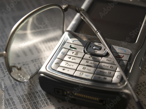 mobile and glasses on phone directory
