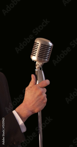 singer holding vintage microphone & stand photo