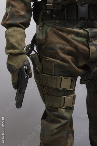 army soldier holding a handgun photo