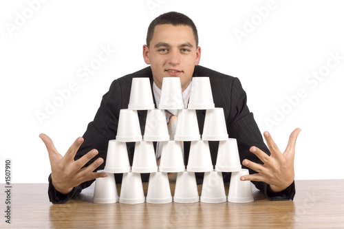 businessman building cups' pyramid photo