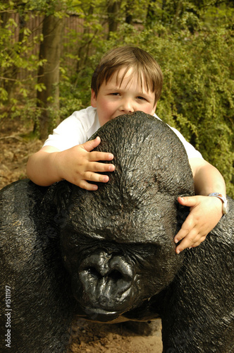 boy having fun with a gorilla statue