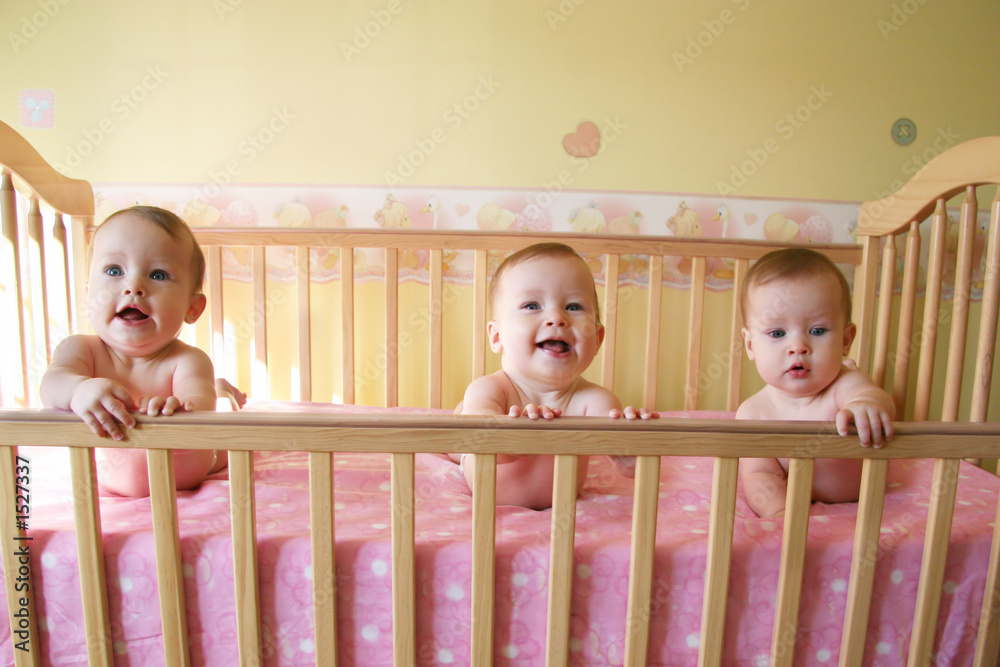 baby girls in crib triplets foto de Stock Adobe Stock