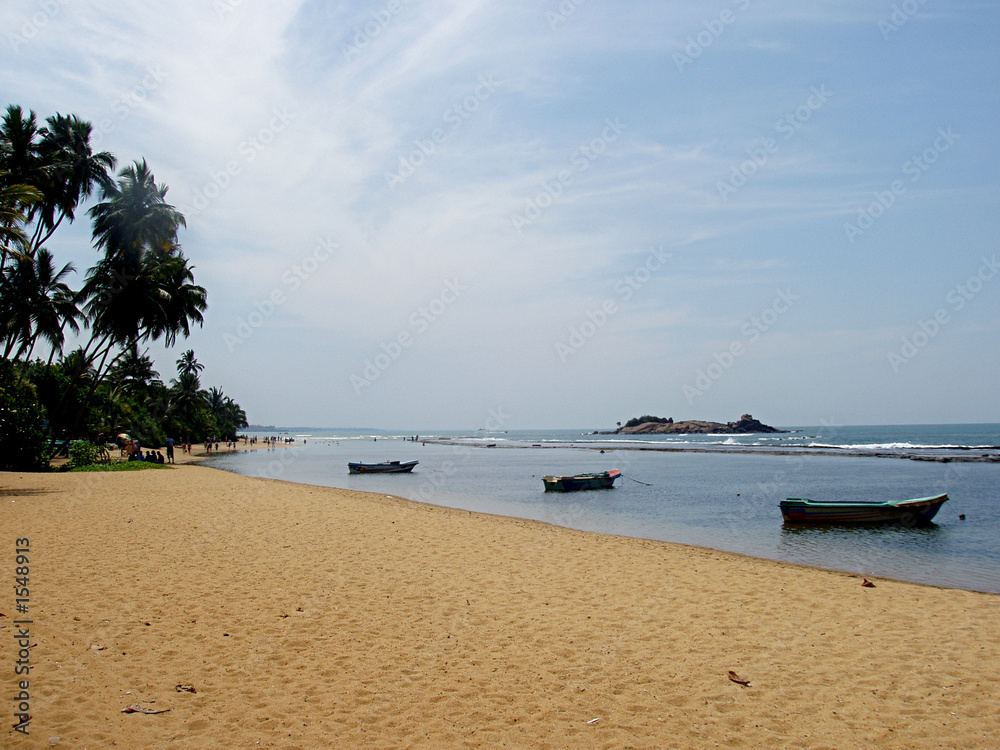 sandy beach with fishing boats