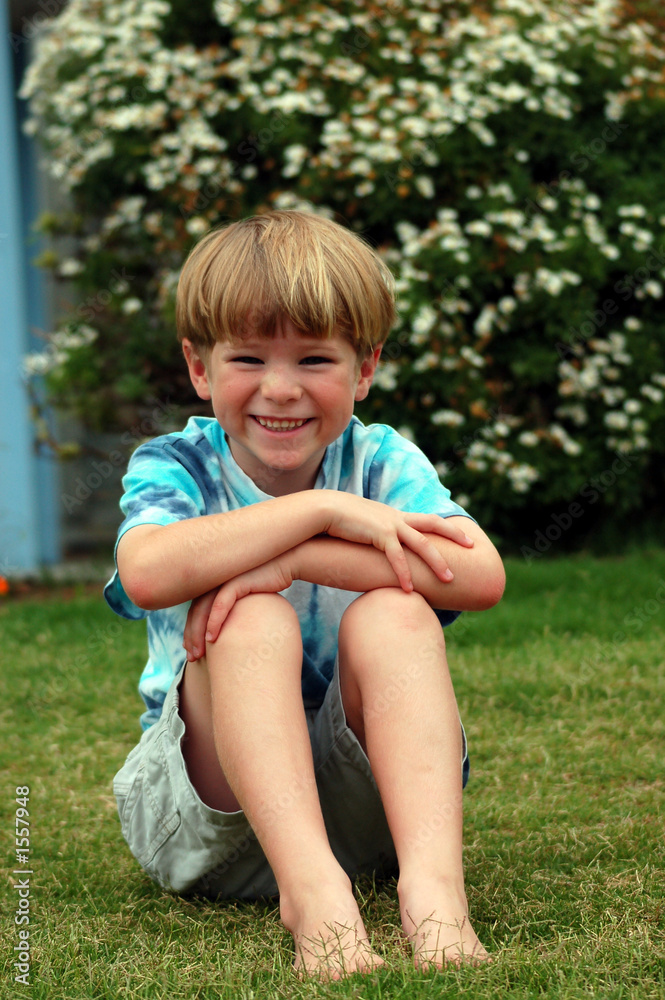 boy sitting in grass boy sitting in grass