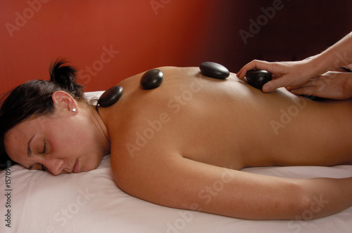 massage hands on with hot mineral stones