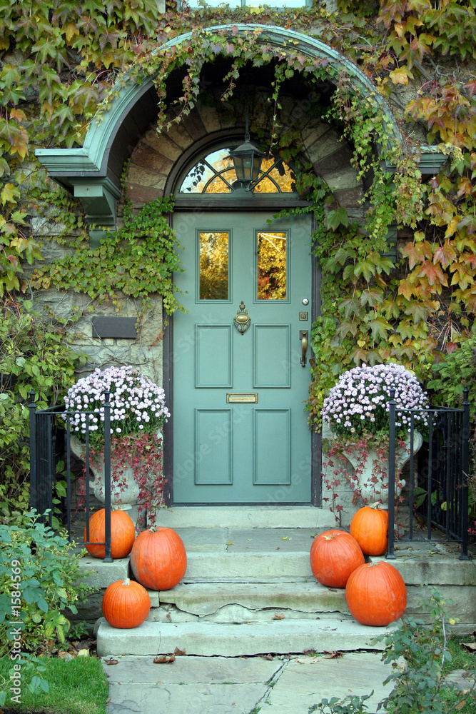 Naklejka premium front door with ivy and pumpkins