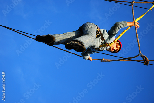 boy standing on a steel wire
