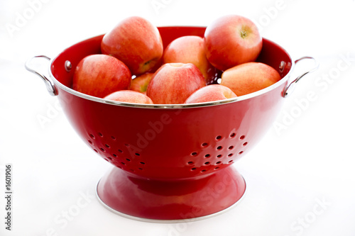 apples in a red colander