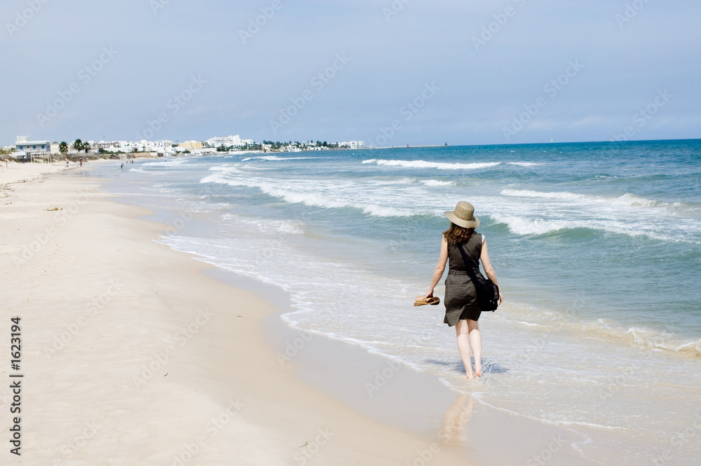 woman walking at the sea beach