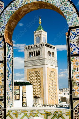 mosque tower - framed with ornamental arch in tuni