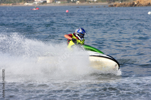 young man speeding along on jetbike during a race photo